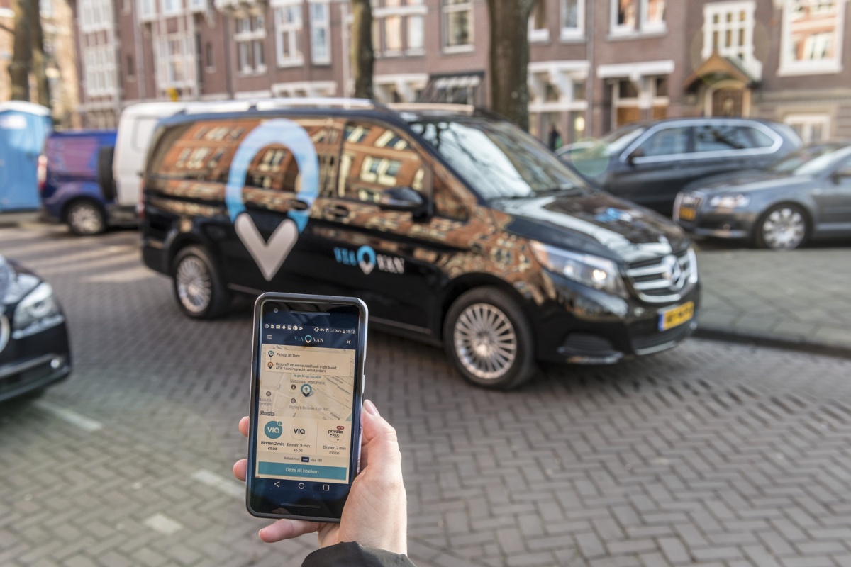Passengers request a ride using the ViaVan app on their phone 