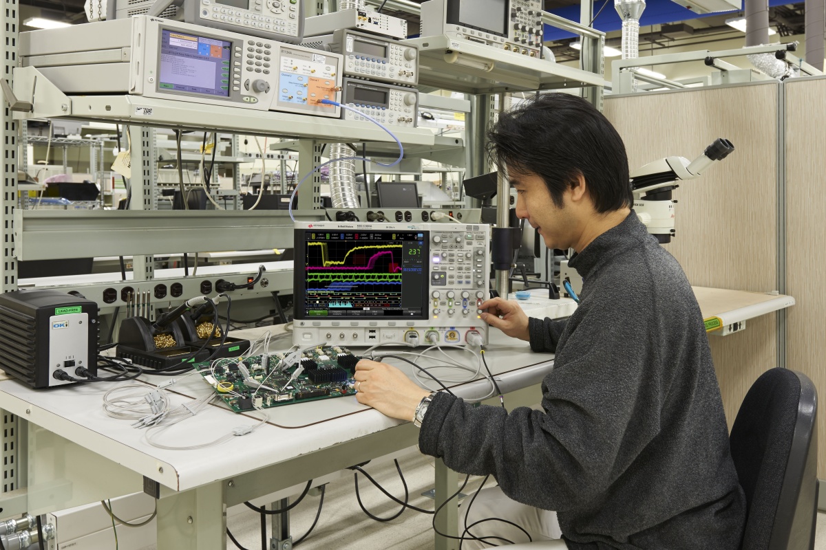Member of the project team from Keysight uses an oscilloscope to look for power line signals