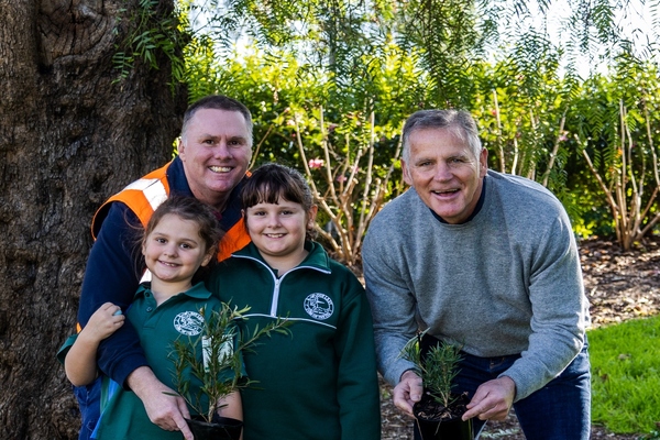 Greater Geelong arborist Daniel Robins with his daughters and mayor Peter Murrihy ahead of National Tree Day. Photo: Lachie Young