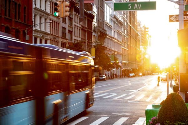 NYC bus driving through 5th Avenue_smart cities_Adobe.jpg